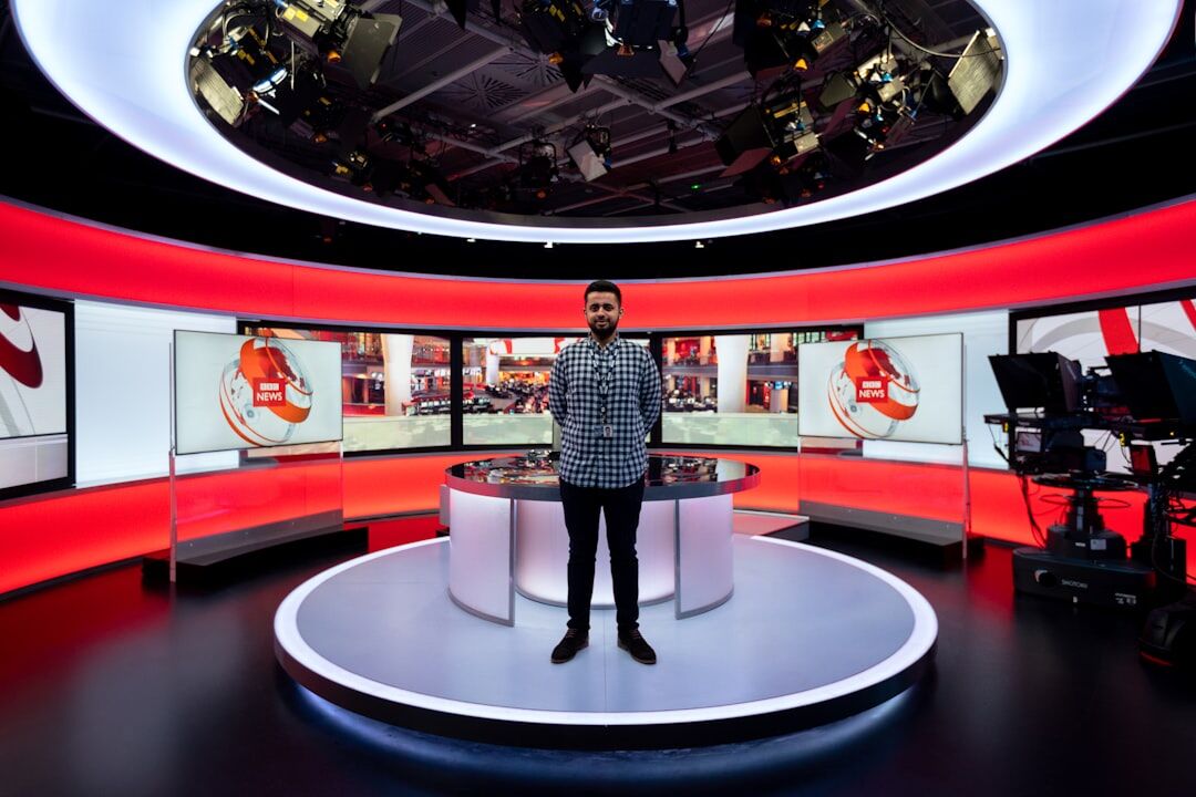 Multiple broadcast cameras positioned around a news studio set